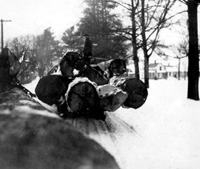 Moving logs up Main St. to the mill